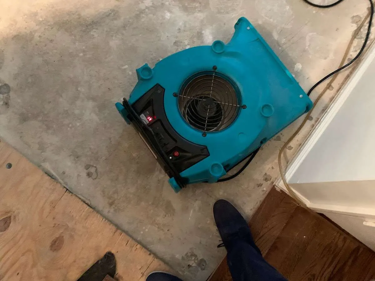 Air mover drying subfloor during Commercial Water Damage Restoration in Coal City